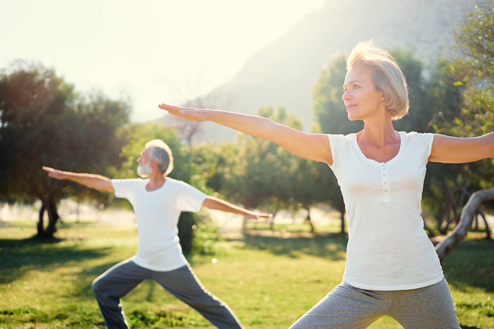 older-couple-doing-yoga-in-park