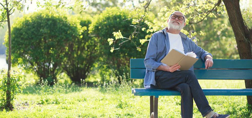 older-man-reading-in-park